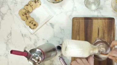 Pouring Milk Into Chocolate While Stirring Until It Changes Color