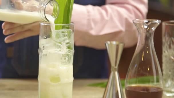 Pour Milk Green Syrup Glass — стоковое видео