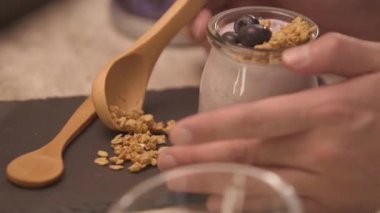 hand taking the garnish using spoon to napkin - static