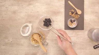 hand putting blueberry on the napkin - static
