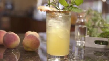 Şeftalili ve biberiyeli bir bardak içki.