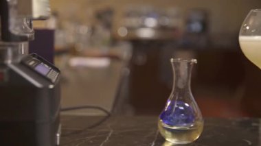  a glass drink with flowers next to jigger - slide right