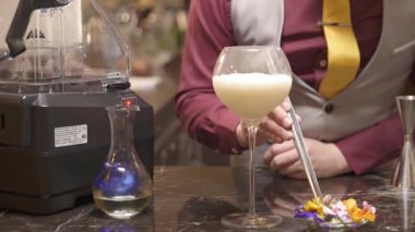 Man picking up flowers to the drink - static