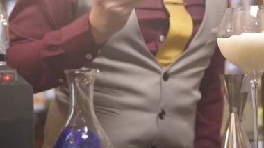  man using the tong to pick up flower petals - panning