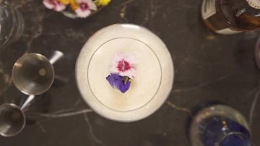 top view of a glass drink with flowers - static.