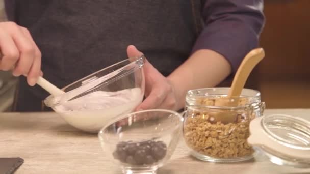 Hands Holding Bowl Mixing Yogurt Slide Left — Video Stock