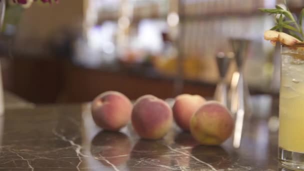 Ein Glas Mit Pfirsich Und Rosmarin Auf Dem Tisch — Stockvideo