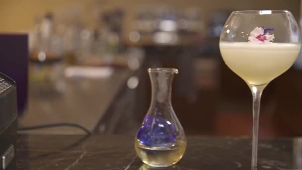 Glass Drink Flowers Next Bottle Slide Right — стоковое видео