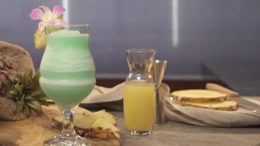 drink with pineapple slice and flower petal - slide right