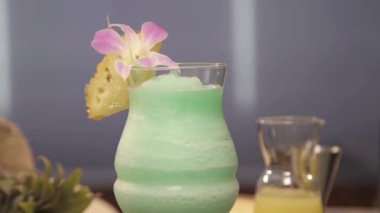  drink with pineapple slice and flower petal - static focus