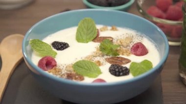  Üstünde böğürtlen olan bir kase smoothie - rafa odaklan