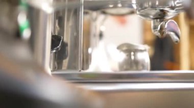 woman attached lever to the coffee machine - static