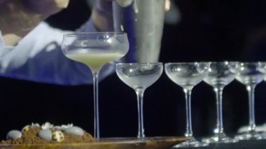 Adam kadehleri cam sırasına dolduruyor.