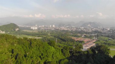 Silhouette of mountain in the distance with trees and the city - static