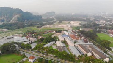Busy roads with car passing by with a view of the misty morning hill and mountain near the city - slide left.