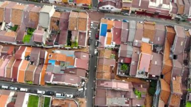 Aerial Shot Of Busy Street Surrounded By Colorful Buildings In Southeast Asia Melaka - Dolly Forward.