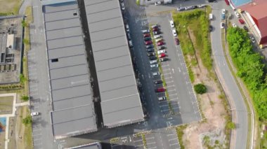 Aerial View Of Parking Lot In Kuala Lipis Tilt Up Mountain View - Pan Right To Left Tilt Up