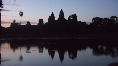 Siyah ışıktaki kaya binaları ve güneş batımındaki su kaynaklarının yansıması - statik