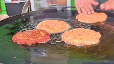 Elle şekillendirilmiş ve yağda kızartılmış hamburger köfteleri.