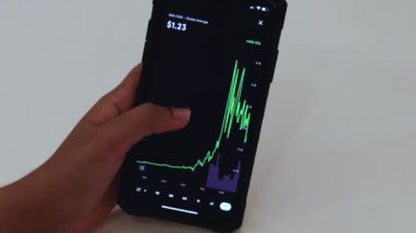 Woman looking through ADA 3 Years chart on Black smartphone