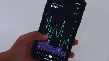 Woman looking through DOT 6 Months chart on Black smartphone