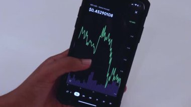  Woman browsing through XRP charts on phone