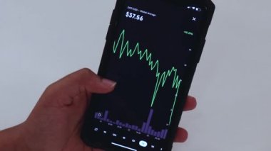 Woman looking through DOT 1 week chart on Black smartphone