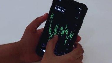 Woman looking through ETH charts on app