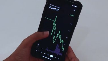 Woman looking through ETH charts on phone