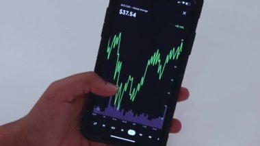 Woman looking through Polkadot charts on cellphone