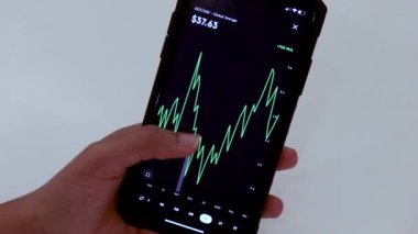 Woman looking through DOT 1 year chart on Black smartphone