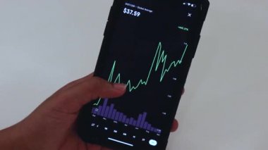 Woman looking through DOT 3 Years chart on Black smartphone