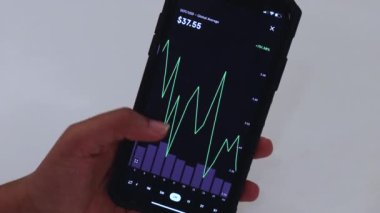 Woman looking through DOT 6 Months chart on Black smartphone