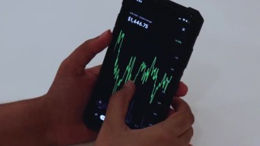 Woman looking through ETH charts on app
