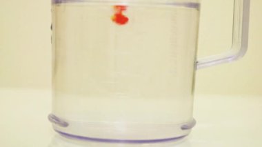 Color Dye Being Added Into Clear Water - Dark Yellow