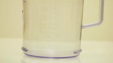Color Dye Being Added Into Clear Water - Light Yellow.
