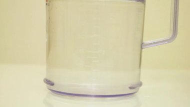 Color Dye Being Added Into Clear Water - Peach