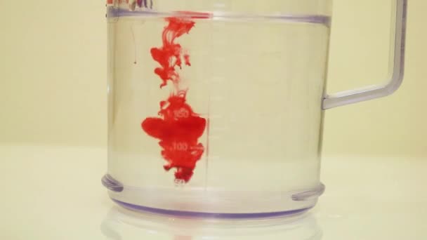 Color Dye Being Added Clear Water Red — Stockvideo