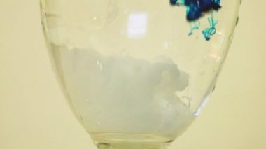 Color Dyes Being Added Into Wine Glass - Blue And White