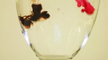 Color Dyes Being Added Into Wine Glass - Pink And Brown.