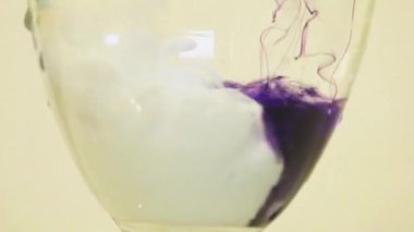 Color Dyes Being Added Into Wine Glass -  Purple And White