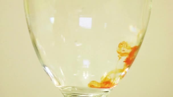 Color Dye Being Added Wine Glass Orange — Stock video