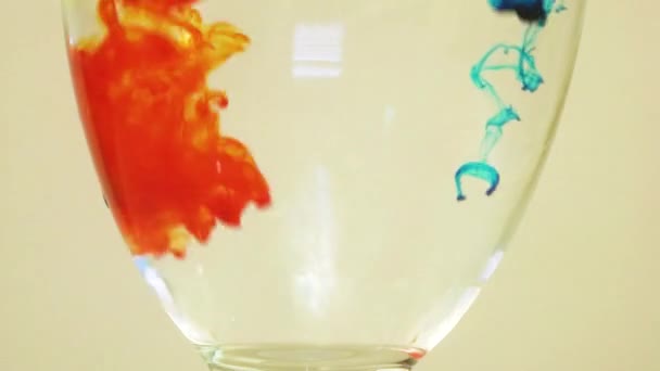 Color Dyes Being Added Wine Glass Blue Orange — Vídeo de Stock