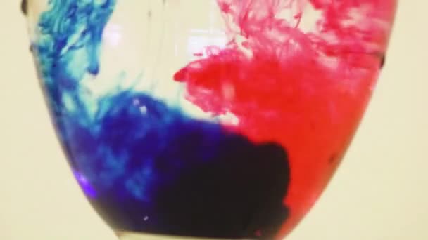 Color Dyes Being Added Wine Glass Pink Royal Blue — Vídeo de Stock