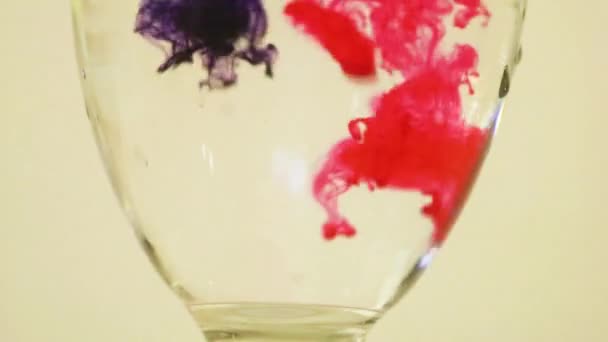 Color Dyes Being Added Wine Glass Pink Purple — Stock video