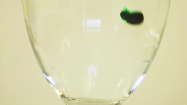 Color Dyes Being Added Wine Glass Purple Green — Stockvideo