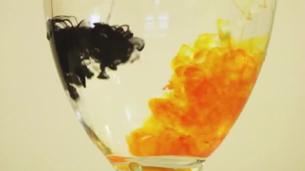 Color Dyes Being Added Wine Glass Yellow Black — Vídeo de Stock