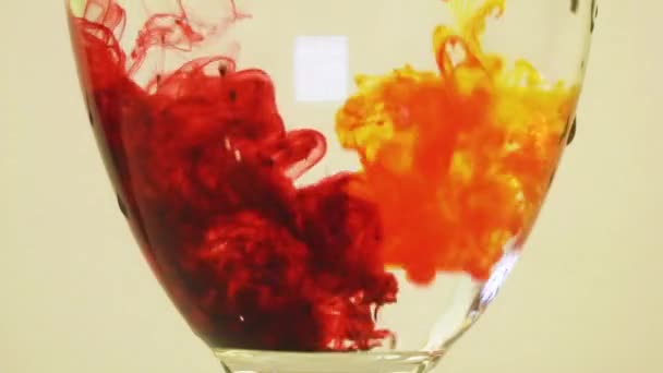 Color Dyes Being Added Wine Glass Yellow Maroon — Vídeo de Stock