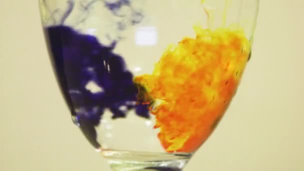 Color Dyes Being Added Wine Glass Yellow Violet — Vídeo de Stock