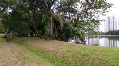 lake Area With Buildings And Nature - Pan Left To Right.